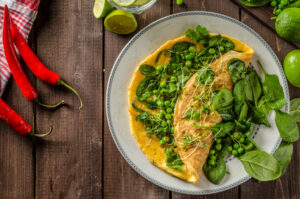 Bio healthy food, egg omelette with herbs, microgreens and peas