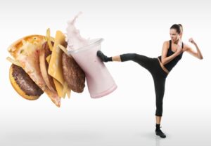 Fit young woman fighting off fast food