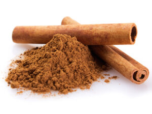 cinnamon sticks with powder isolated on white background