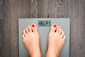 Lose weight concept with person on a scale measuring kilograms